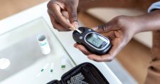 Image of someone using a blood sugar tester